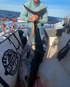 Angler holding a large tuna caught offshore on San Francisco Bay